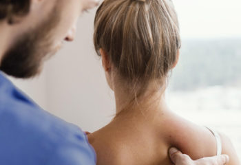 side-view-male-osteopathic-therapist-checking-female-patient-s-spine